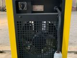 an image of a yellow and black air compressor sitting on top of a pallet