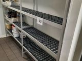 a metal shelving in a kitchen with a lot of shelves