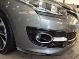 a close up of a car ' s headlight and front bumper