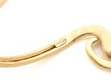 an image of a close up of a gold bracelet on a white background