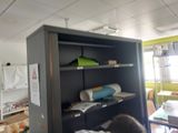 a man that is standing in front of a bookcase