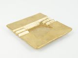 gold plate with a plane on it sitting on a white surface