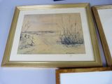 two framed pictures of a beach scene on the wall