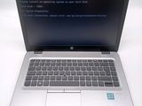 a laptop that is open on a white table