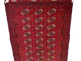a red rug with a pattern on it and fringes