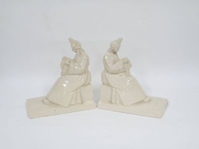 une paire de figurines en céramique blanche représentant une femme et un homme
