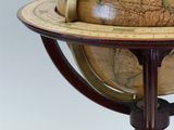 a large globe that is on a stand on a table
