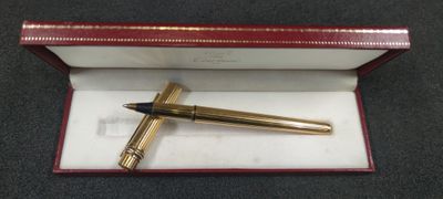 an image of a pen in a red box on a table