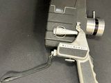 an old movie projector with a camera attached to it