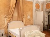 a bedroom with a bed, chair, and fireplace in it