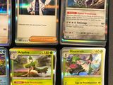 a lot of pokemon cards that are on the table