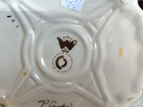 a white bowl with a crown on it on a table