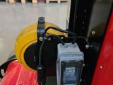 a small camera attached to the side of a red vehicle