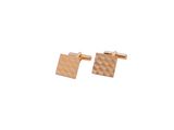 a close up of a pair of gold cufflinks on a white background