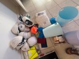 a pile of items on the floor next to a toilet