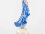 figurine of a woman in a blue robe standing on top of a white base