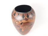a vase with a painting on it on a white surface