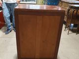 a man standing next to a cabinet in a room