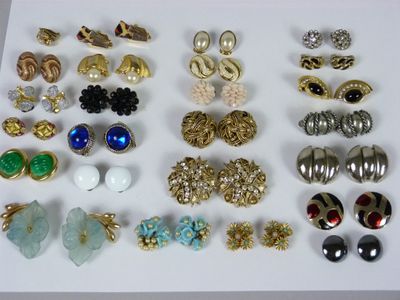 many different types of earrings on a white surface