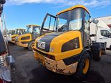 a lot of yellow construction vehicles parked in a parking lot