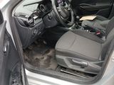 the interior of a car with the door open and the driver ' s seat down