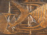 an image of a metal plaque with a fish on it