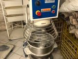 a mixer that is sitting in a kitchen next to a stack of boxes