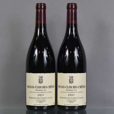 two bottles of wine sitting on top of a table next to each other