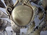 a gold plate with a picture of a bird on it