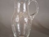 a clear glass pitcher sitting on a table