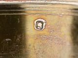 a close up of a metal container with a face on it