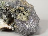 a rock with a hole in it on a white surface