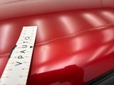 a measuring tape on the seat of a red car