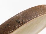 a close up of a wooden object on a white surface