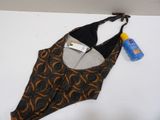 a bathing suit with a bottle of sunscreen and a bottle of sunscreen next to it