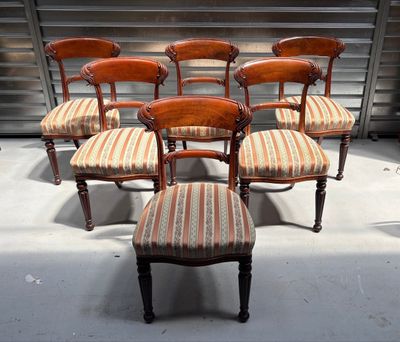 six antique chairs with striped upholstered seats in a room