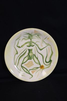 a plate with a painting on it on a black background