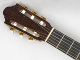 a close up of an acoustic guitar with a white background
