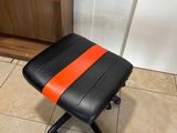 a black and orange stool sitting on a tiled floor