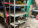 a metal rack with tools on it in a garage