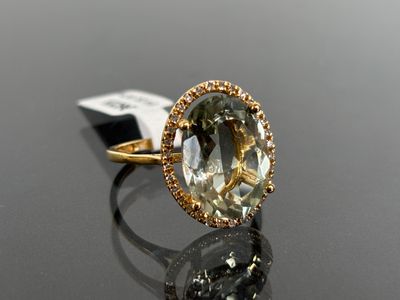an image of a yellow gold ring with a green and white diamond