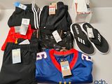a lot of clothing and shoes on a table