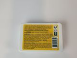 a close up of a white container with a yellow label on it