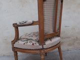 a wooden chair with a plaid upholstered seat