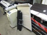a pile of luggage sitting on the floor next to a refrigerator