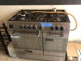 a stove that is sitting in the middle of a kitchen
