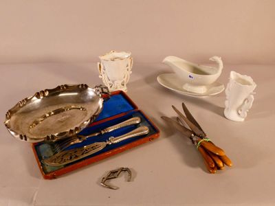 a silver plate and a pair of scissors on a table