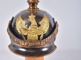 a black and gold helmet with a gold eagle on it