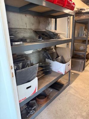 many pots and pans on the shelves in the kitchen
