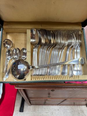 a lot of silver spoons and spoons in a box